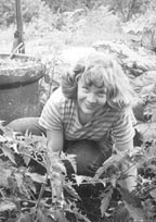 Esther weeding the tomatoes.